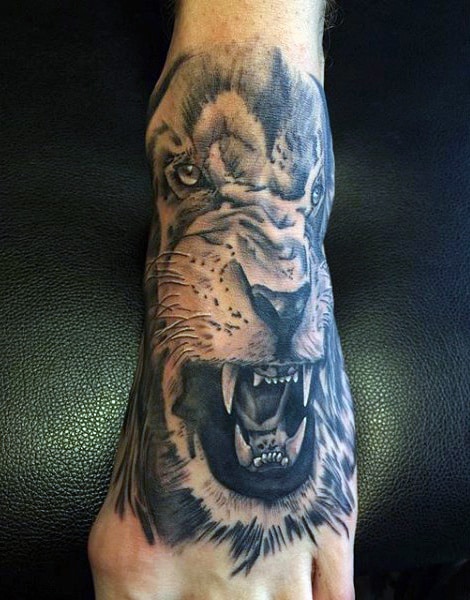 Tattoo of a roaring lion's face covering the foot