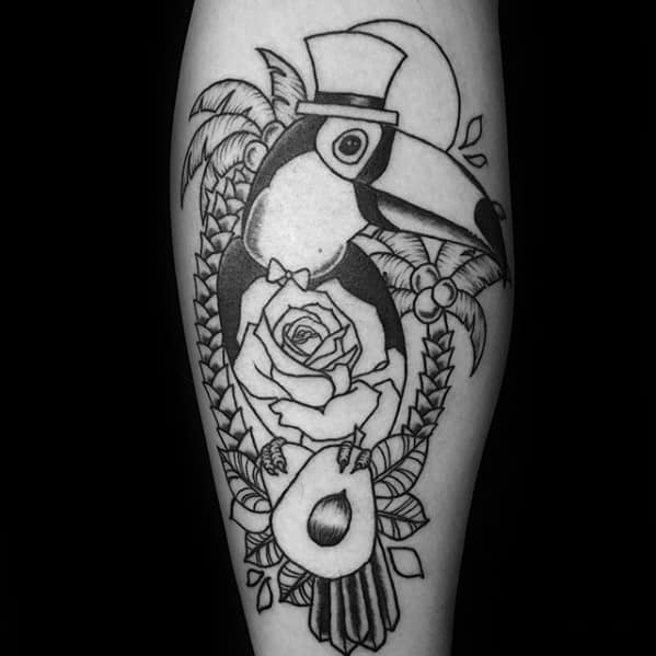 Blackwork toucan tattoo wearing a top hat and bow tie, surrounded by palm trees, a rose, and avocado for a quirky and elegant vibe.
