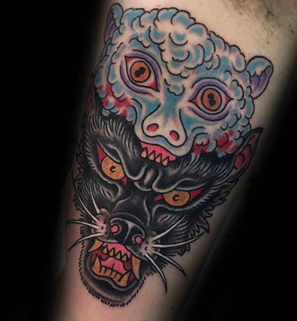 Tattoo of a wolf's head below a sheep's head, both with sharp teeth and vivid colors