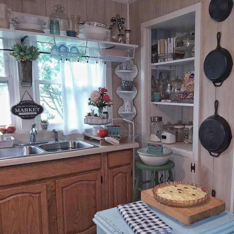 cluttered country kitchen hanging pans window shelves recessed shelves