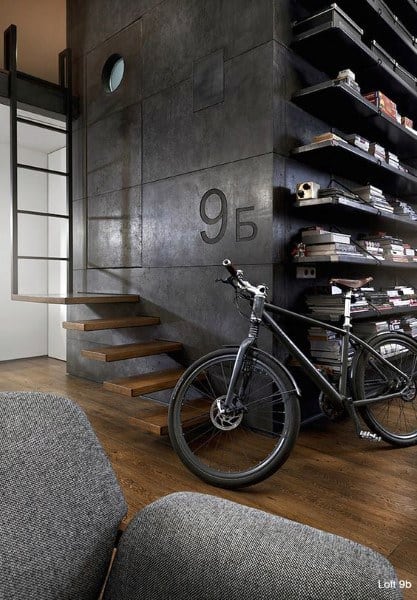 Industrial loft with floating wooden stairs, metal shelving, and bicycle storage area.