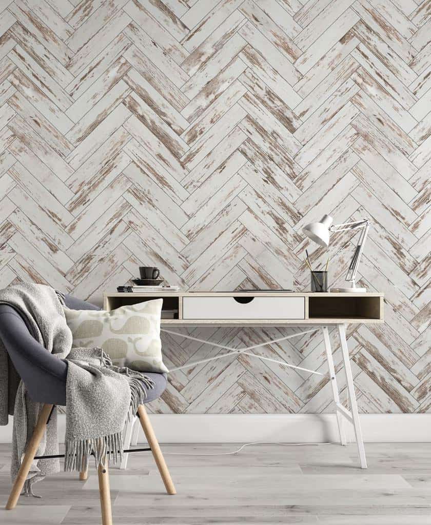 Home office with distressed chevron shiplap wall and cozy reading chair.