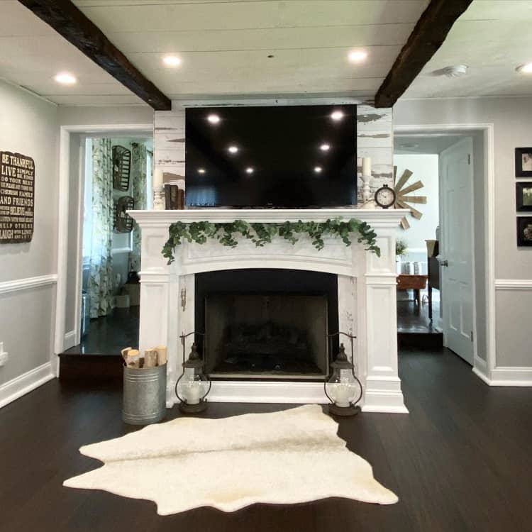white ornate fireplace hardwood floors animal skin rug