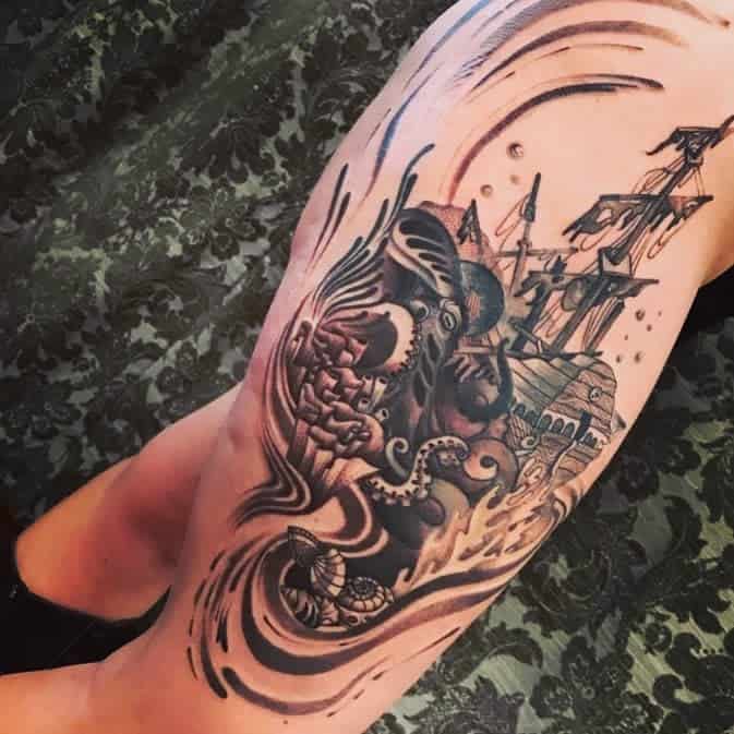 Black and gray tattoo of a pirate ship being overtaken by a giant octopus, with swirling ocean water and abstract motion lines