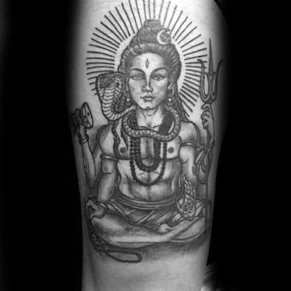Tattoo of Lord Shiva in a meditative pose with radiant halo, holding a trident and damru, adorned with snakes and rudraksha beads.