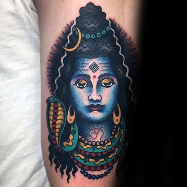 Vibrant tattoo of Lord Shiva with a serene blue face, crescent moon, coiled snake, colorful beads, and Om symbol on the neck.