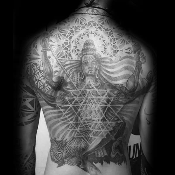 Full-back tattoo of Lord Shiva in a powerful stance, layered with sacred geometry, tiger skin, and intricate cosmic and tribal patterns.