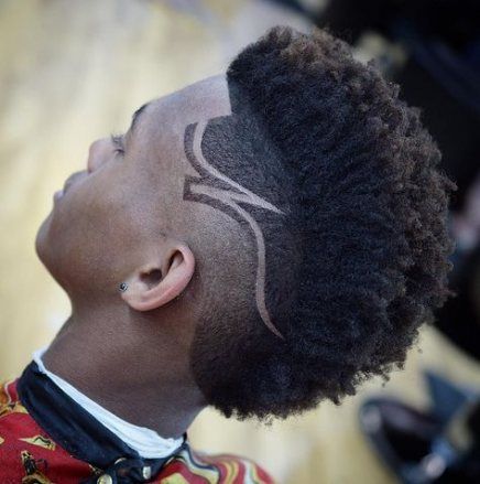 A frohawk hairstyle featuring long hair on top and faded sides with stylish designs