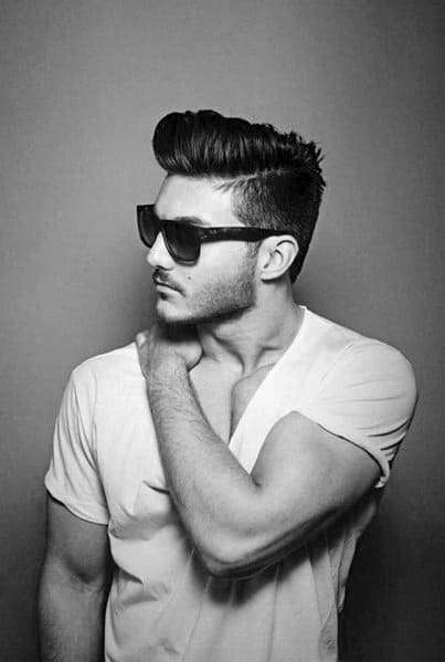 High pompadour with a clean undercut and a subtle side part