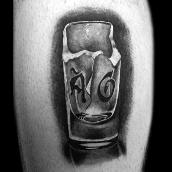 Realistic black and grey shot glass tattoo with a cracked effect and stylized lettering inside, creating a bold and detailed design.