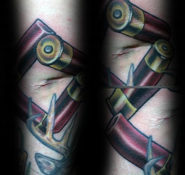 Realistic shotgun shell tattoo featuring bold red and gold casings with detailed shading, placed over a torn-skin effect for a dynamic look.