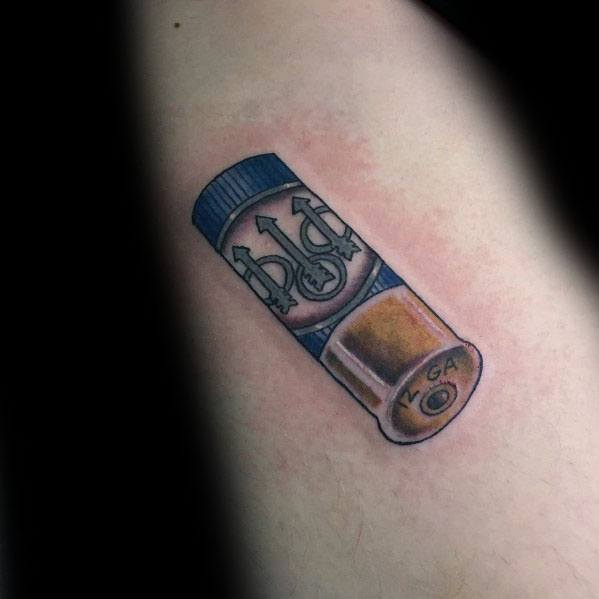 Realistic shotgun shell tattoo featuring the Beretta logo, with detailed shading and blue and gold tones for a bold and clean design.
