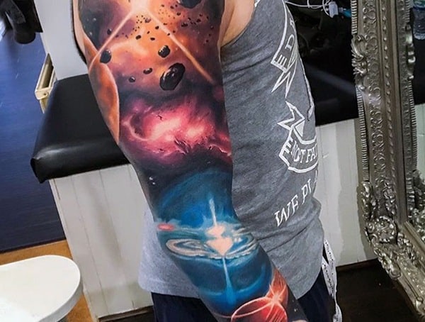 A person with a vibrant space-themed sleeve tattoo