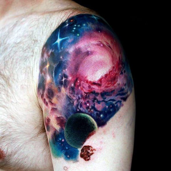 Nebula tattoo featuring a colorful galaxy and planet on the upper arm