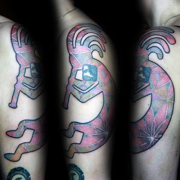Geometric Kokopelli tattoo with intricate dotwork and vibrant colors, creating a sparkling, multidimensional effect on the arm.