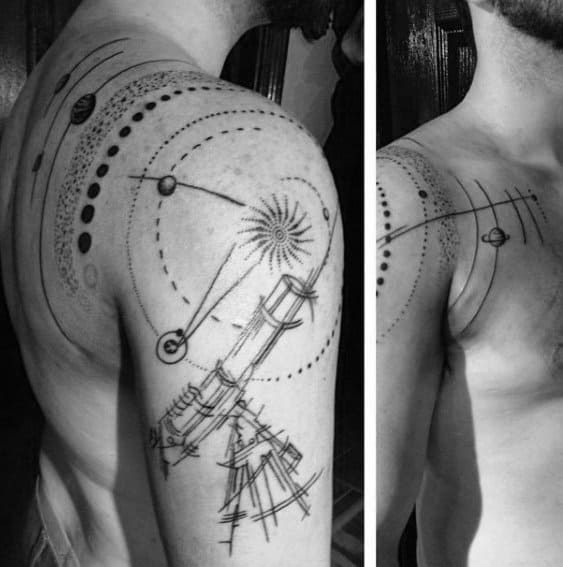 Telescope-inspired black and white space tattoo on a man's shoulder and upper arm