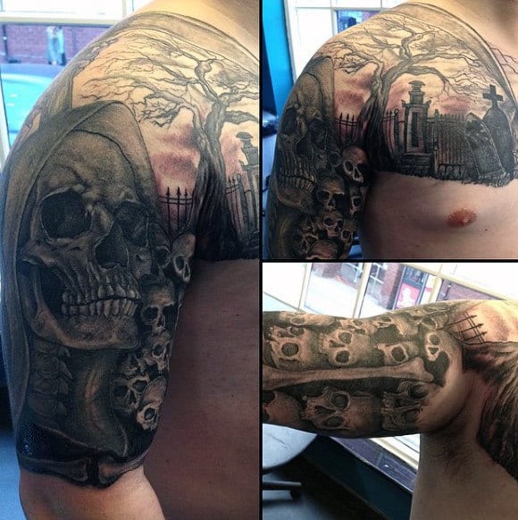 Man with a detailed Grim Reaper and skull tattoo sleeve on upper arm and chest against a haunting graveyard backdrop