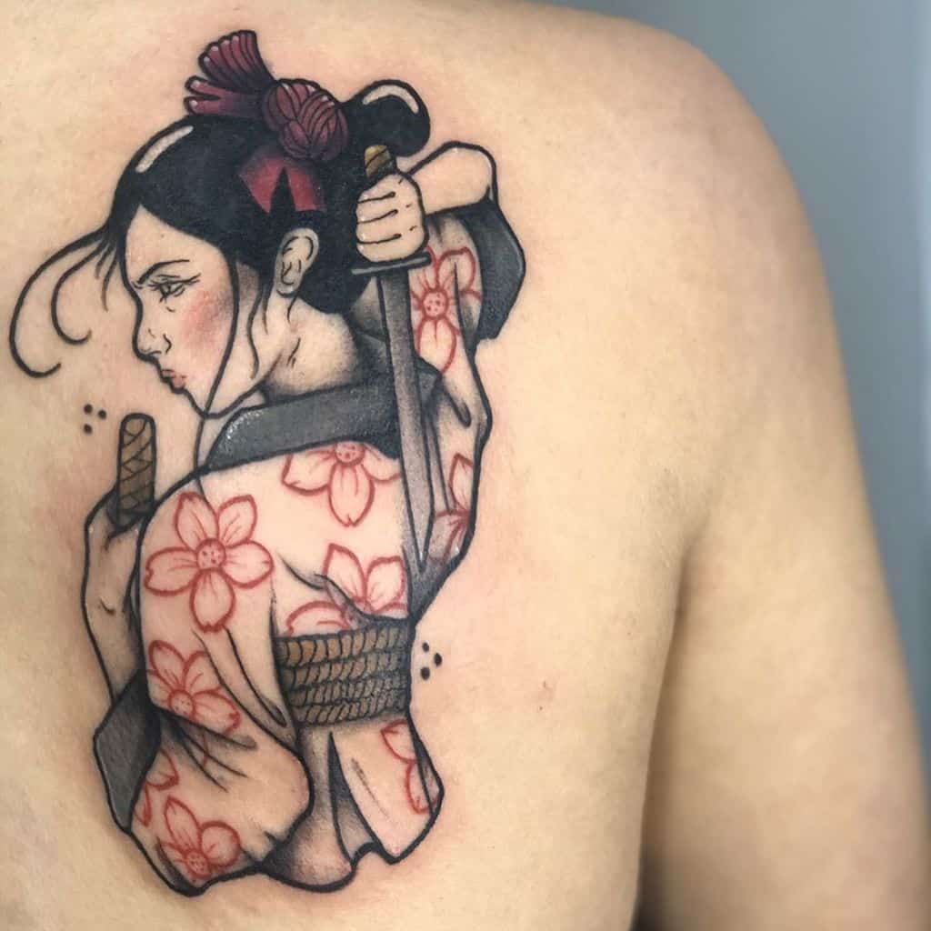 Back tattoo of a warrior Geisha in a floral kimono, holding a katana with a determined gaze, blending elegance with strength.