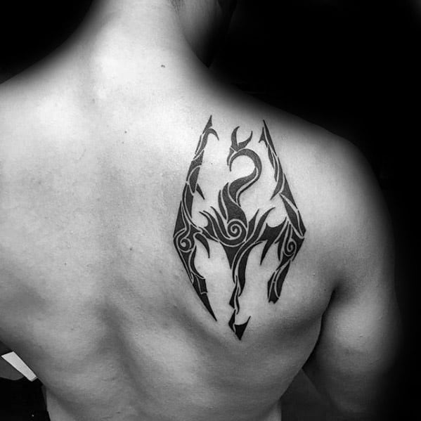 Back tattoo of a Skyrim dragon encased in a stylized geometric design