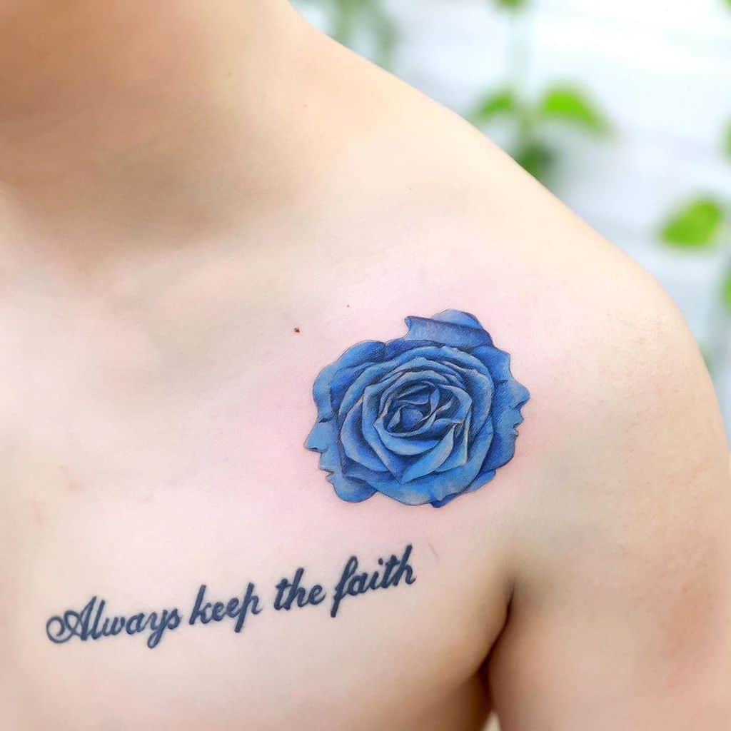 A striking tattoo of a blue rose graces the shoulder, with the words "Always keep the faith" elegantly scripted beneath, combining artistry and inspiration