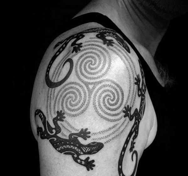 Tribal gecko tattoo on shoulder with three swirling spiral patterns at the center, surrounded by lizards in a circular motion.