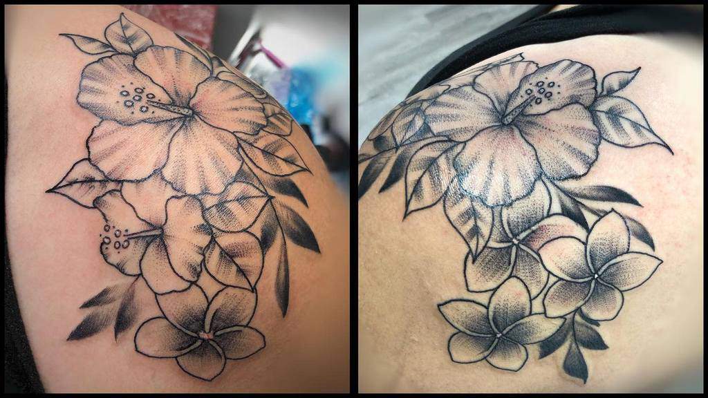 Black and grey shaded shoulder tattoo featuring a large hibiscus and multiple plumeria flowers, with leaves surrounding the floral arrangement