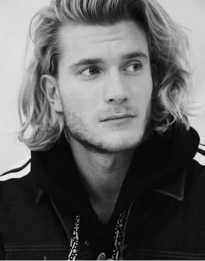 A textured haircut featuring shoulder length hair with layers to add volume