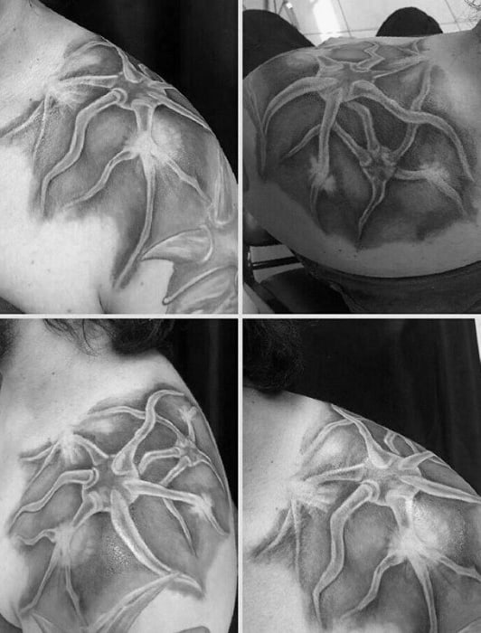 Black and grey neuron tattoo on shoulder and upper back with a 3D effect, featuring soft shading and raised, web-like neural structures.