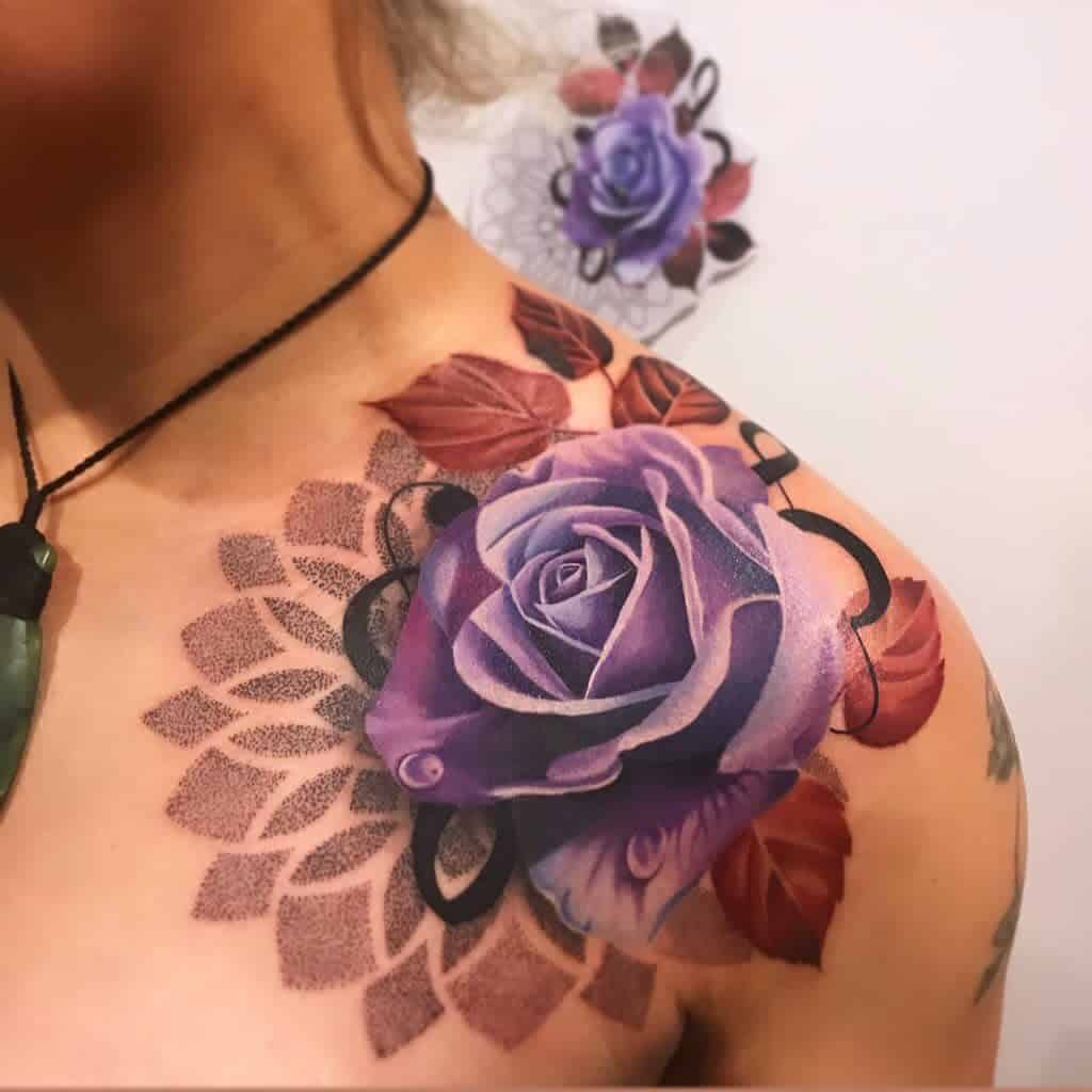 Tattoo of purple rose with leaves and geometric pattern on a shoulder