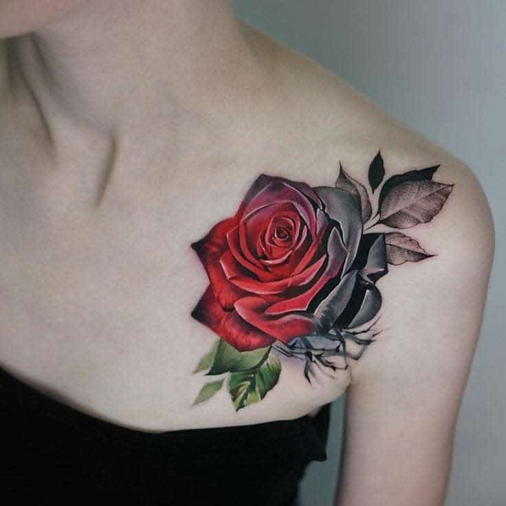 A beautifully crafted tattoo of a red rose blooms lifelike on the woman's shoulder, capturing attention with its vibrant elegance