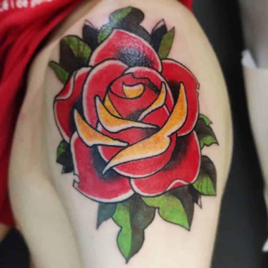Traditional tattoo of a red and yellow rose with green leaves on skin