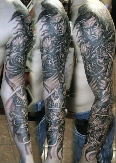 Detailed samurai-themed sleeve tattoo on a person's arm