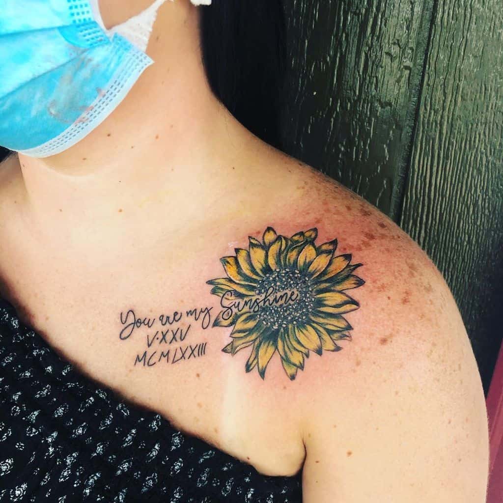 Colorful sunflower tattoo with cursive text on shoulder