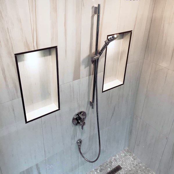 Contemporary shower with sleek LED lighting highlighting recessed shelves, creating a modern and functional design