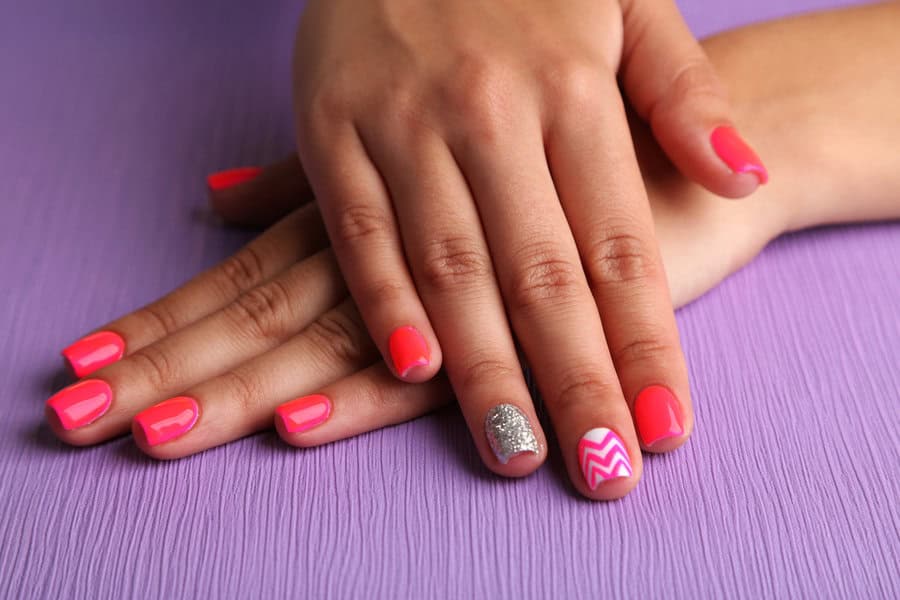 Pink nails with silver glitter and zigzag accent