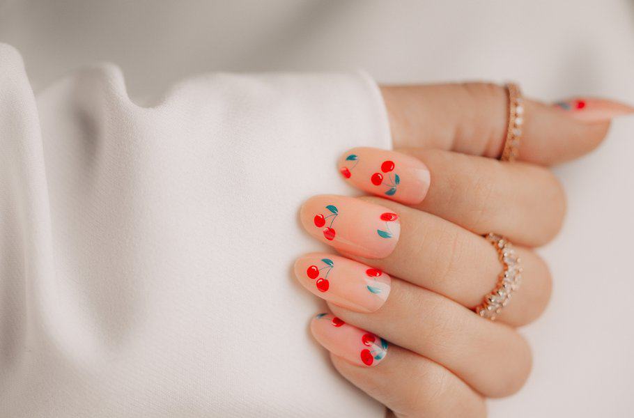 Cherry-themed nail art close-up