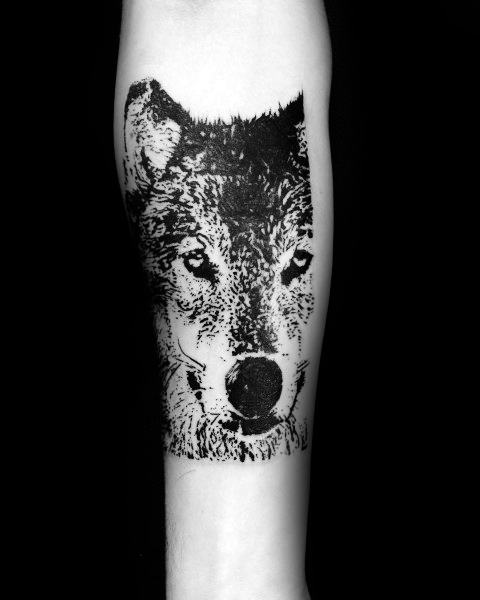 Bold blackwork Siberian Husky tattoo on a man's forearm, featuring a high-contrast, textured design for a striking and artistic look.