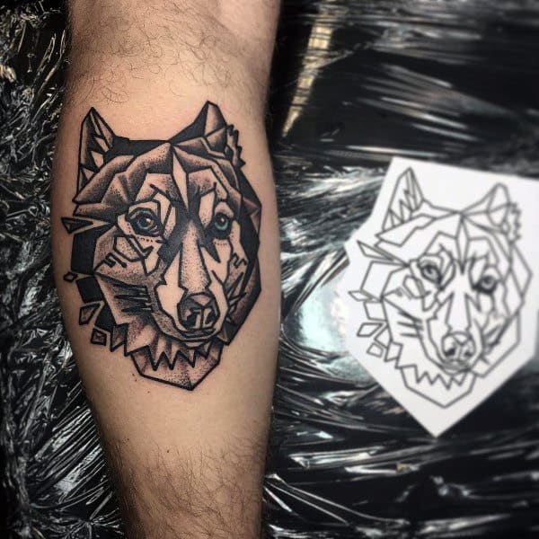 Geometric Siberian Husky tattoo on a man's arm, featuring bold black outlines, sharp angular shapes, and intricate shading for a modern artistic look.