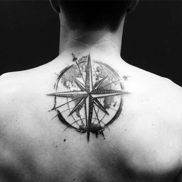 Detailed compass tattoo on the upper back with fine shading and a world map design, symbolizing navigation, adventure, and exploration.