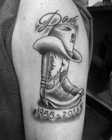 Black and white tattoo of a cowboy boot with a hat, inscribed with "Dad" and the years 1953-2016, serving as a heartfelt memorial tribute.