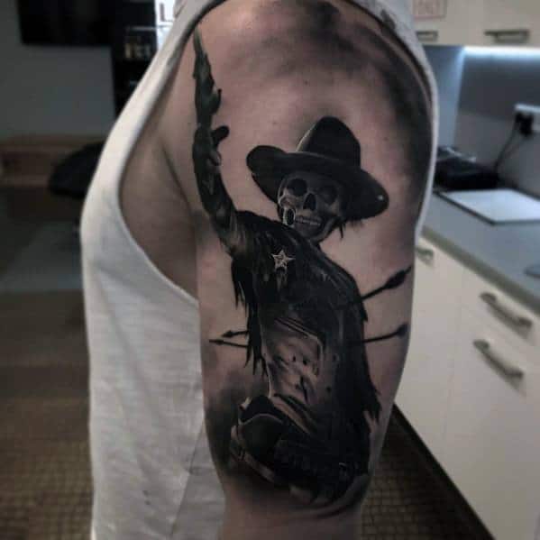 Black and gray tattoo of an undead cowboy sheriff with a skull face, wearing a wide-brimmed hat and tattered coat, aiming a gun in a dramatic pose.