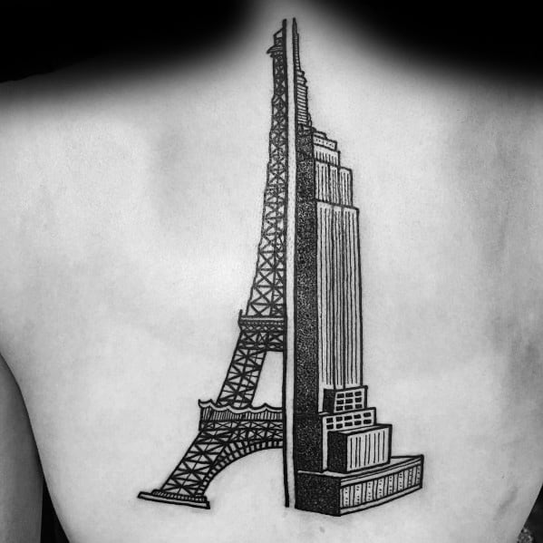Bold black tattoo merging the Empire State Building and Eiffel Tower, symmetrically designed on a man's upper back.
