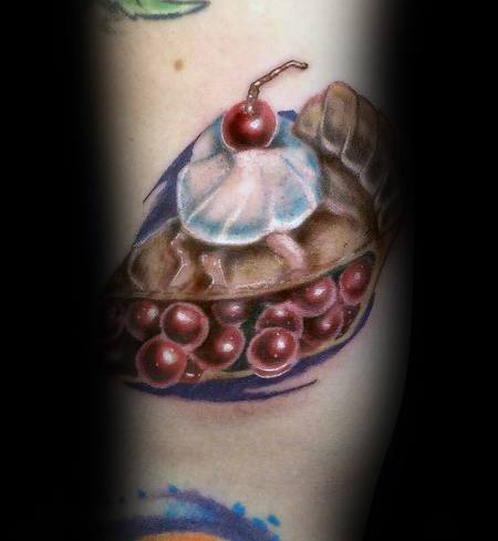 Realistic cherry pie tattoo with a flaky crust, rich filling, whipped cream, and a cherry on top, creating a detailed and mouthwatering design