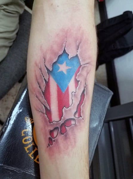 Puerto Rican flag tattoo with a torn skin effect, revealing vibrant red, white, and blue colors with a bold star underneath.