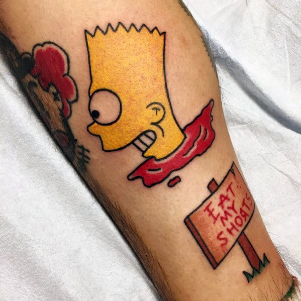 Bold tattoo of Bart Simpson’s severed head with a mischievous grin, next to a sign that says 'Eat My Shorts' in red letters.
