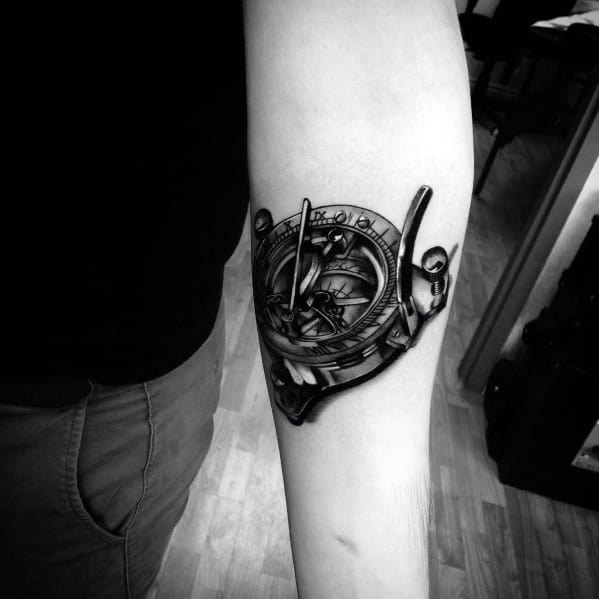 Realistic sundial compass tattoo with intricate shading and 3D effects, creating a bold and detailed design symbolizing time and direction.