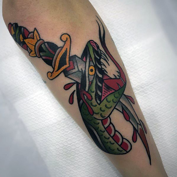 Traditional snake and dagger tattoo on forearm, featuring bold colors, dynamic shading, and blood drops for a striking old-school design.