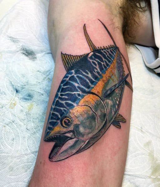 Realistic tuna fish tattoo on a man's leg, featuring vibrant colors, intricate shading, and reflective water effects for a lifelike ocean-inspired design.