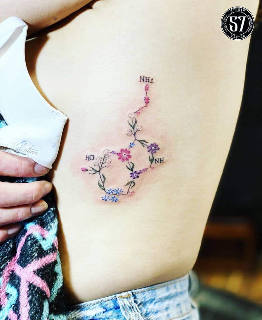 A serotonin-inspired floral chemical structure tattoo on a woman's side
