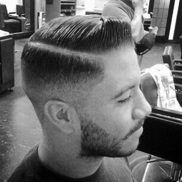 Slick, classic side part with a hard part and a clean fade